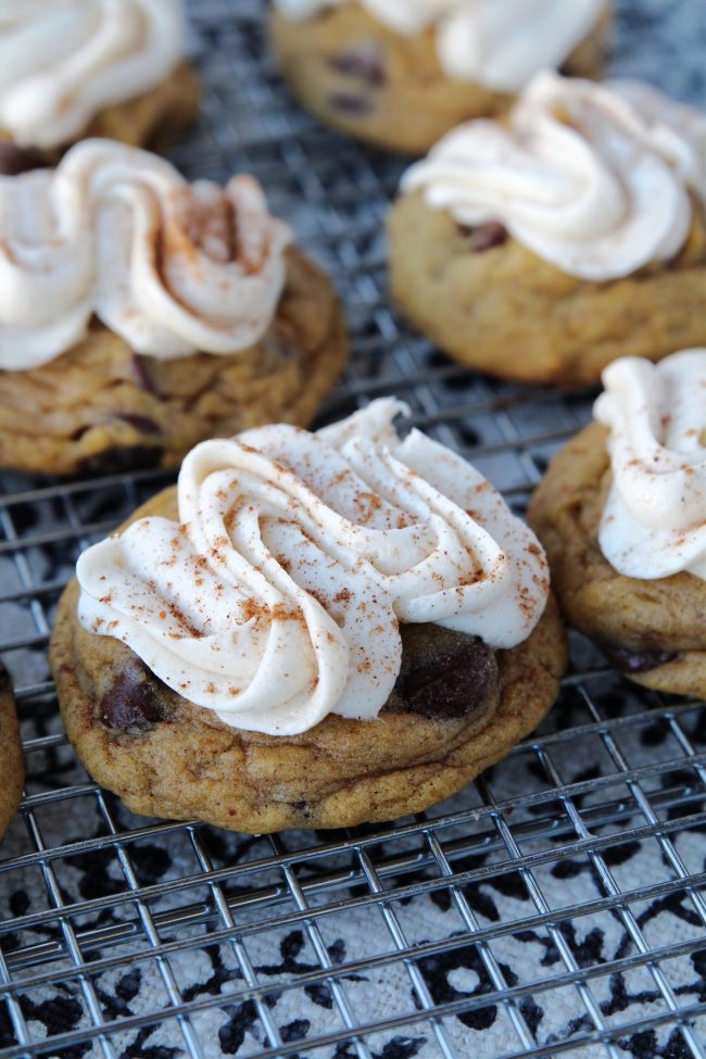 chocolate chip pumpkin cookies topped with cream cheese frosting