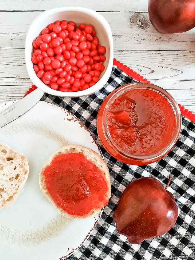 apple spread with red cinnamon candies in slow cooker