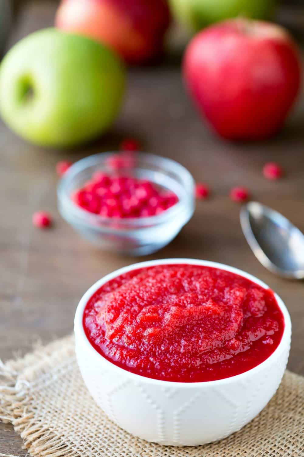 apple spread with red cinnamon candies in slow cooker