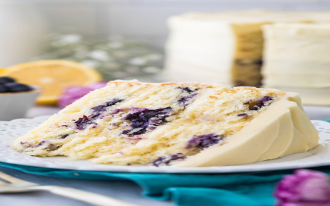 blueberry infused cake topped with cream cheese frosting